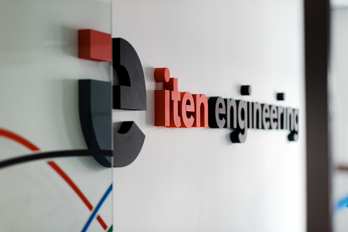 The ITEN Engineering logo on the office wall